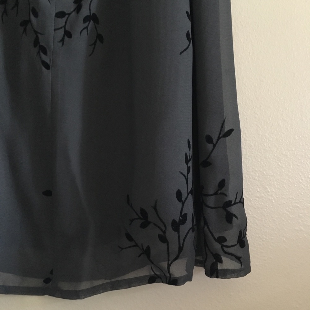 Grey dress with black nature detailing.